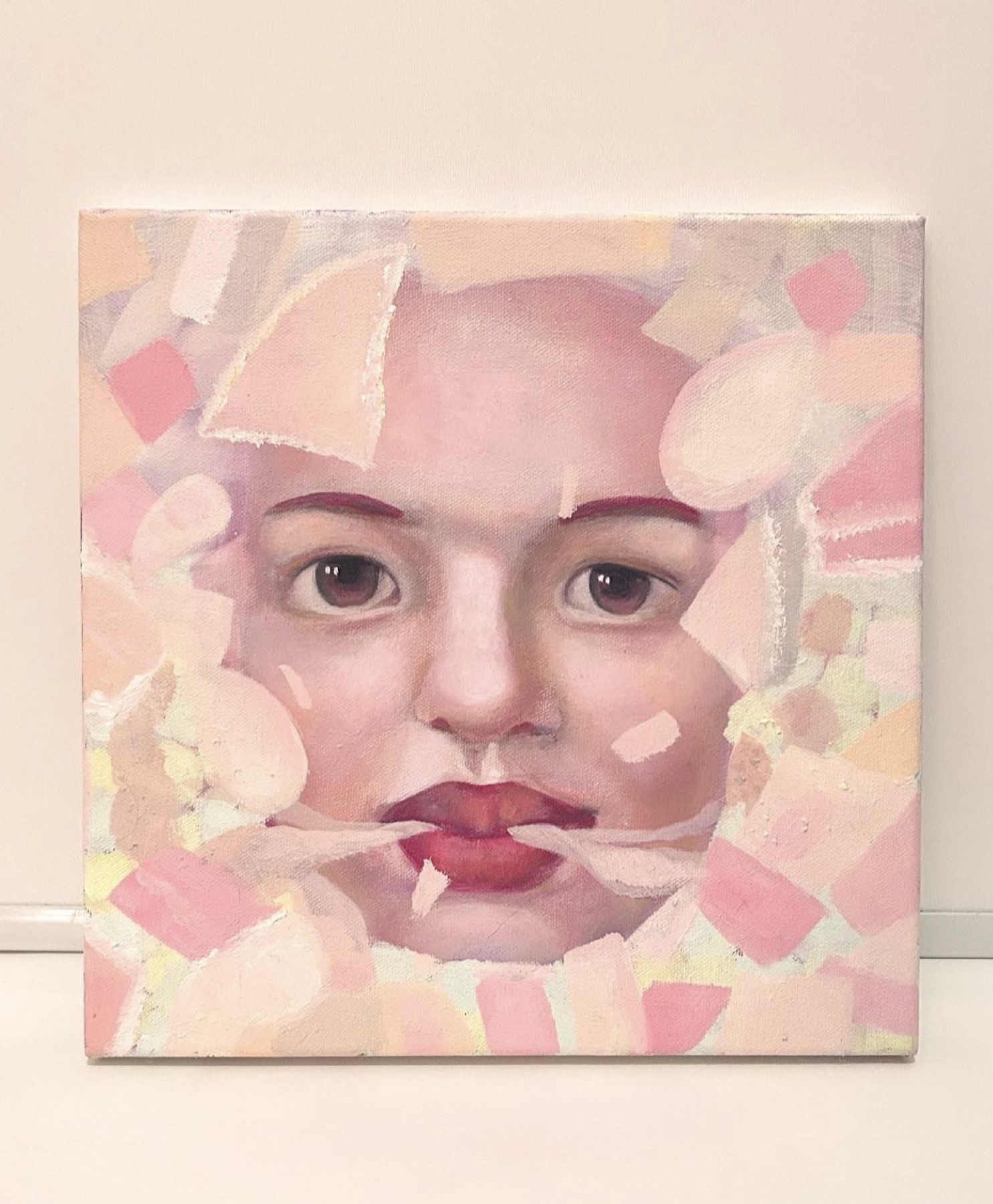 Portrait painting of a face emerging through layered pink and cream fragments